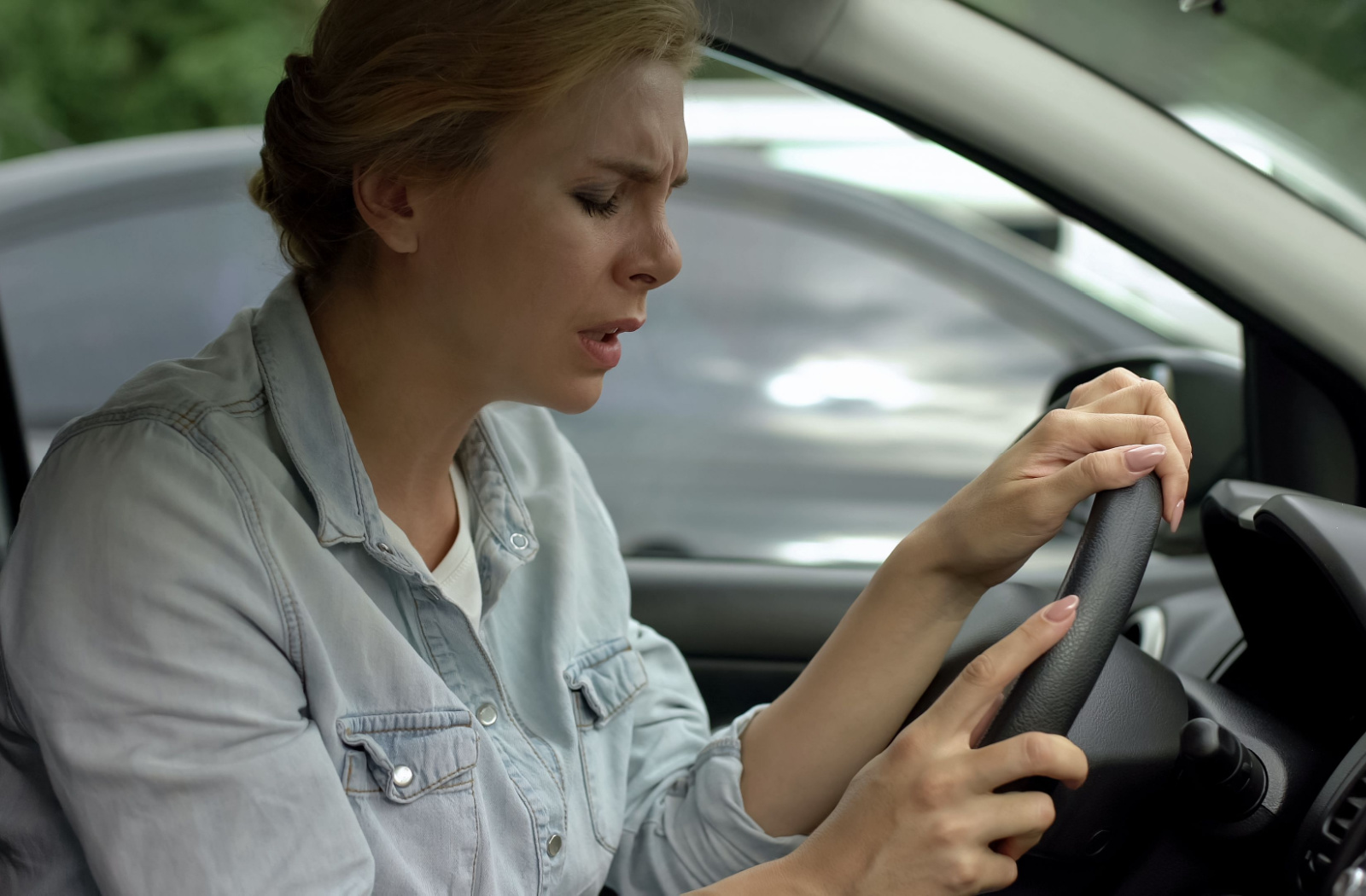A woman suddenly feels uneasy and dizzy while driving
