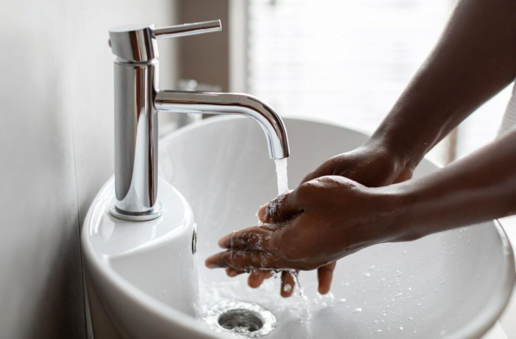 A close-up of a person washing their hands using running water.