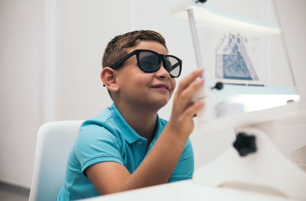 A child at an optometrist undergoes a vision test to look for eye misalignment.