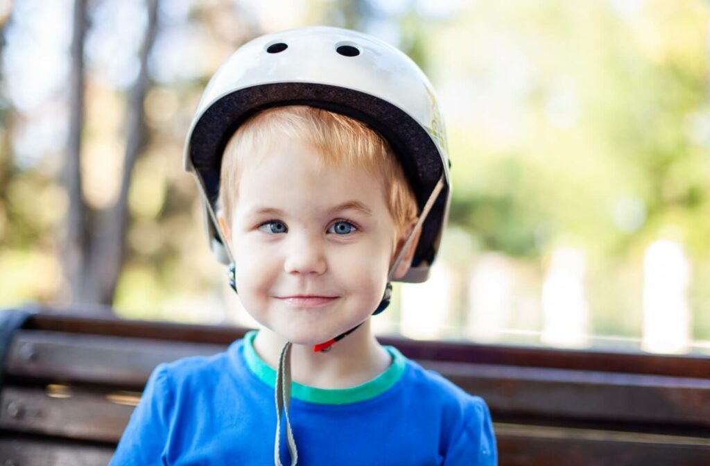 Close up of a young boy wearing a helmet with strabismus (crossed eyes)