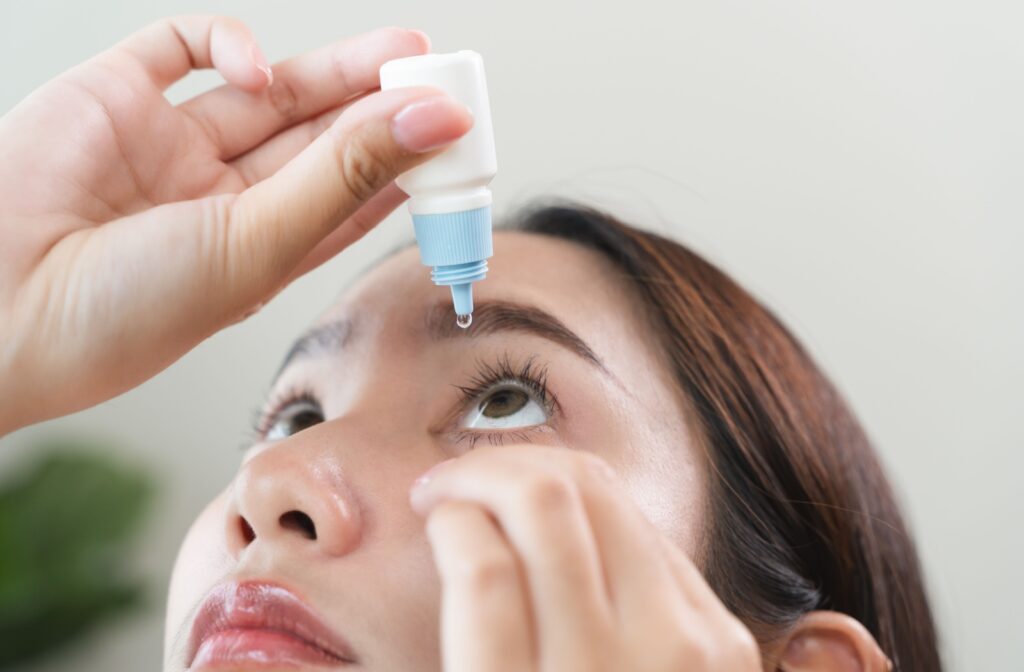 Young Asian woman using artificial tears to treat her dry eye.