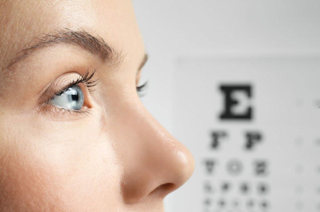 A person undergoing an eye muscle tracking test by focusing on a moving light during an eye exam.