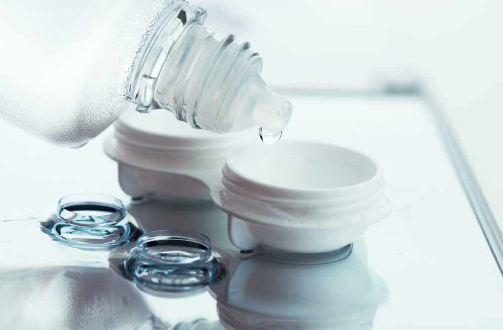 Eye care solution being poured into a contact lens case to ensure cleanliness and proper storage.