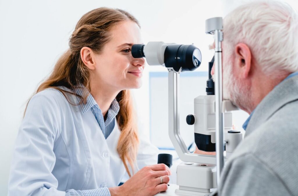 Optometrist examining an older adult’s eyes with a slit lamp during a comprehensive eye exam for dry eye treatment.