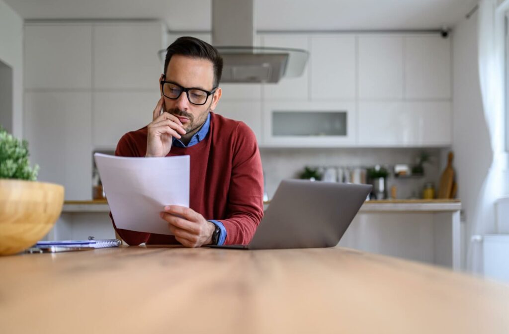 An adult looking over health insurance documents.